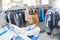 Girl worker hangs Laundry clean clothes on a hanger