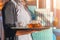 Girl working as waitress holding a tray with tea