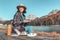 girl working at a computer while relaxing in a country nature Park. The purest mountain lake in the background