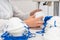 The girl works in a factory for the production of medical masks with nanofibre and solder loops with ultrasound on a machine.