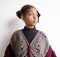 Girl wrapped in gray and amaranth poncho with decoration i