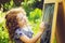 Girl writes in chalk on a blackboard. Education concept. Toning