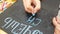 Girl writing chalk on a blackboard