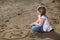 Girl writing number in the sand