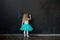 Girl writing something with a chalk on blackboard