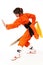 The girl wushu in orange costume in low guard