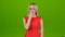 Girl yawns covering her mouth with hand. Green screen studio