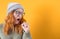 Girl yawns. Sleepy young woman yawning, isolated on yellow background