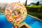 Girl in yellow bikini hold inflatable doughnut