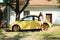 Girl with yellow car New Beetle