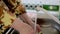 Girl in yellow coat thoroughly washes dishes and cup with soap during coronavirus. Close-up