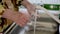 Girl in yellow coat thoroughly washes her hands with soap during coronavirus