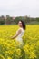 A girl in a yellow flower field, a beautiful spring landscape, a bright sunny day, canola.