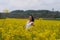 A girl in a yellow flower field, a beautiful spring landscape, a bright sunny day, canola.