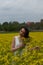 A girl in a yellow flower field, a beautiful spring landscape, a bright sunny day, canola.