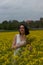 A girl in a yellow flower field, a beautiful spring landscape, a bright sunny day, canola.