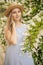 Girl in yellow hat. Young woman looking at camera on summer blurred countryside