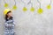 Girl in yellow helmet with light bulb ideas