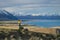 Girl in yellow jacket looking at Lake Tekapo from Mount John observatory, South Island, New Zealand