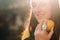 A girl in a yellow shirt with lemons in her hands on a city street. Portrait of a woman in yellow