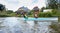 A girl and a young man on a kayak, tourists rafting in a blue boat, Matrosovka river