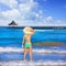 Girl young standing looking at the sea beach hat