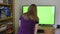 Girl young woman blonde watching chroma key green tv screen hopping