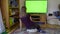 Girl young woman blonde watching chroma key green tv screen sitting