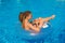 Girl with zizi cornrows dreadlocks lying in swimming circle