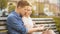 Girlfriend and boyfriend sitting on bench, using tablet, choosing place to go