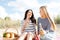 Girlfriends with bottles of beer on the beach