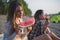 Girlfriends eating watermelon on the beach