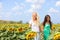 Girlfriends holding hands in sunflower field