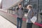 Girlfriends standing at bus stop and waiting for bus