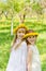 Girlfriends are standing with wreaths of dandelions on their heads