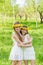 Girlfriends are standing with wreaths of dandelions on their heads