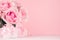 Girlish gentle Valentine days background - exquisite pink roses and heart with ribbon and bow, gift box on white wood board.