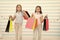 Girlish happiness. Kids happy carry bunch packages. Shopping with best friend concept. Girls like shopping. Kids happy