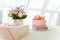 Girlish pink cake with baubles, golden crown and number 1. One year old first birthday party. Candy bar with flowers and present