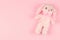 Girlish soft toy on a pink gentle background