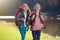 On a girls adventure. Shot of two young girls wearing backpacks walking together beside a lake.