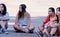 Girls from the audience, sitted on the floor, watch a concert at FIB (Festival Internacional de Benicassim)