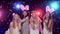 Girls at bachelorette party having fun dancing, throws glitter confetti