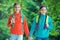 Girls backpackers friends fleece clothes backpacks forest background, family hike concept