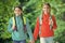 Girls backpackers friends fleece clothes backpacks forest background, family hike concept
