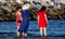 Girls on the beach in the east wearing a red and blue dress with their feet in the water, watching the sea relax, a photo taken at