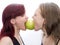 Girls bite apple