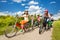 Girls and boys in helmets ride bikes together