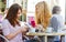 Girls in a cafe with handy