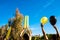 A girls cheer with colorful balloons by lifting them to the sky